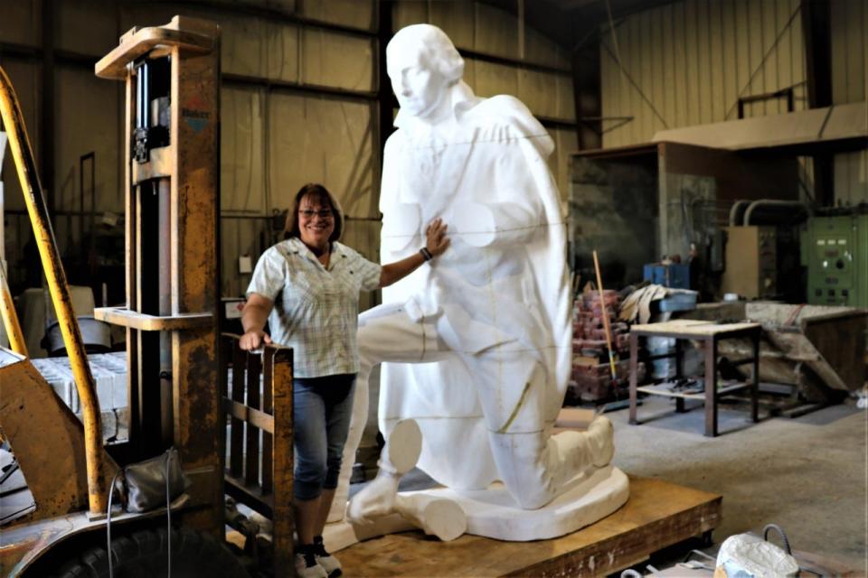 Sculptor Jennifer Frudakis-Petry of Plumstead stands with a Styrofoam version of her sculpture, "Washington Kneeling in Prayer," to be unveiled May 20 at the Washington Crossing National Cemetery in Upper Makefield.