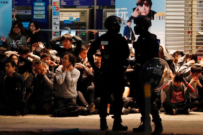 Riot police detain anti-government protesters in a large scale during a legal demonstration on the New Year's Day to call for better governance and democratic reforms in Hong Kong