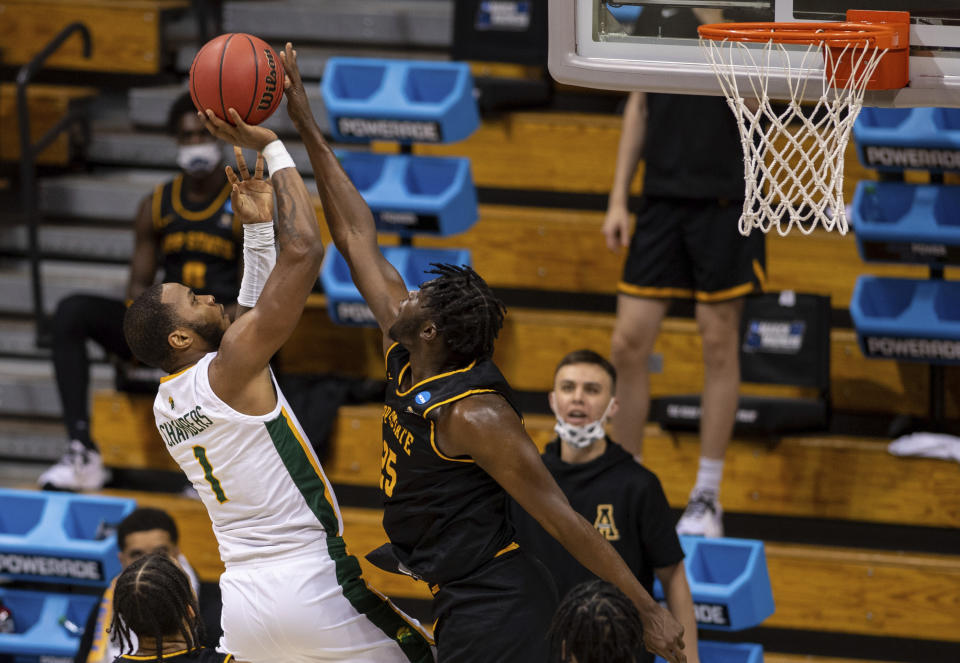 Appalachian State forward James Lewis Jr. (25) blocks a shot by Norfolk State forward Nyzaiah Chambers (1) during the first half of a First Four game in the NCAA men's college basketball tournament, Thursday, March 18, 2021, in Bloomington, Ind. (AP Photo/Doug McSchooler)