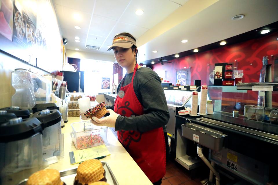 Assistant manager Allyson Jurgensen makes chocolate covered waffle bowls with sprinkles at Cold Stone Creamery Wednesday, January 25, 2023, in Appleton, Wis. The store is located at 3420 E. Calumet Street and will be going through renovations.Dan Powers/USA TODAY NETWORK-Wisconsin. 