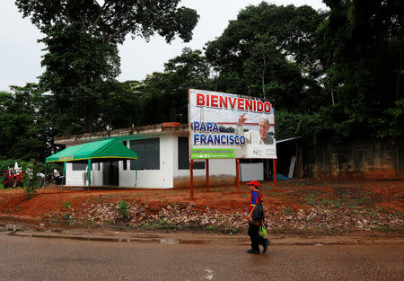 A man walks past a poster of Pope Francis along a street in Puerto Maldonado, ahead of the papal's visit to Peru, January 18, 2018. REUTERS/Henry Romero