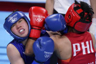 Philippines's Nesthy Petecio, right, exchanges punches with Japan's Sena Irie during their women's featherweight 60-kg final boxing match at the 2020 Summer Olympics, Tuesday, Aug. 3, 2021, in Tokyo, Japan. (AP Photo/Frank Franklin II)