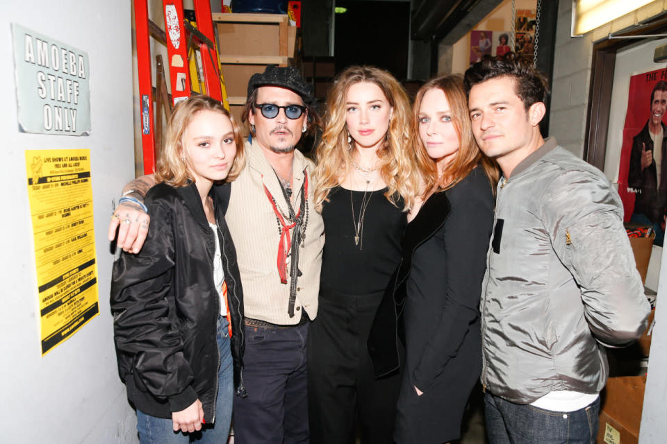 Lily-Rose Depp, Johnny Depp, Amber Heard, Stella McCartney, and Orlando Bloom backstage at the designer’s autumn 2016 show at Amoeba Music in Los Angeles.
