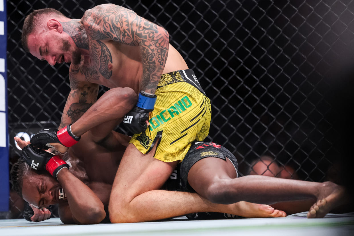 LAS VEGAS, NEVADA - APRIL 13: Jalin Turner and Renato Moicano of Brazil grapple during their  lightweight fight at T-Mobile Arena on April 13, 2024 in Las Vegas, Nevada. (Photo by Carmen Mandato/Getty Images)