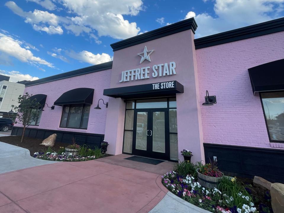 The Jeffree Star store: Pink store with black borders and "Jeffree Star" logo and clouds in the background