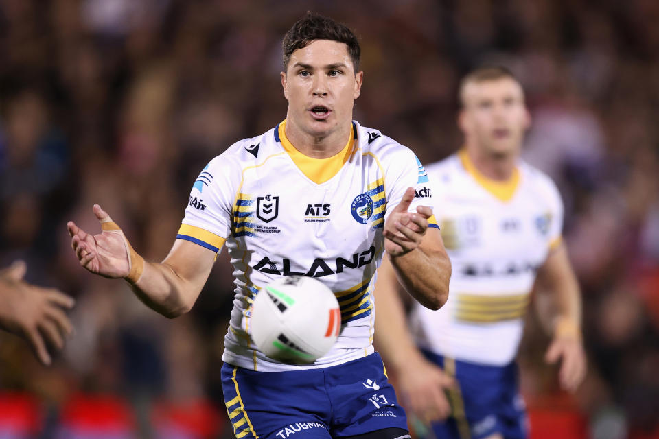 Mitchell Moses passes the ball.