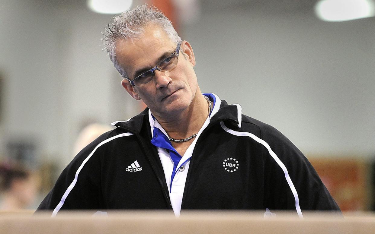 Gymnastics coach John Geddert watches his students during a practice - Reuters