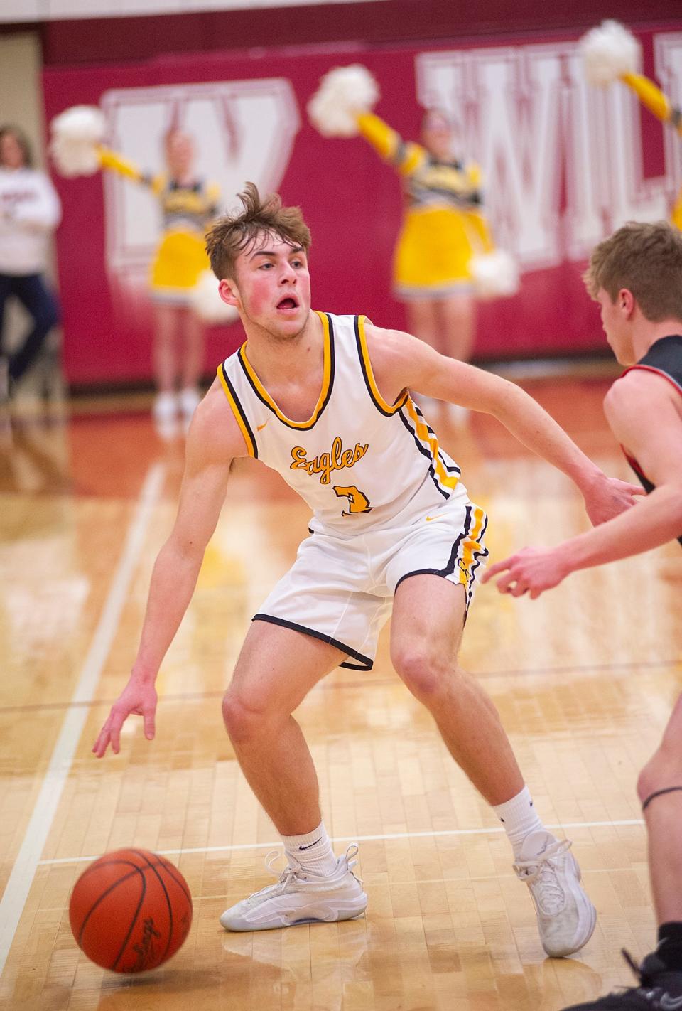 Colonel Crawford's Derek Horsley dribbles the ball at the top of the key.