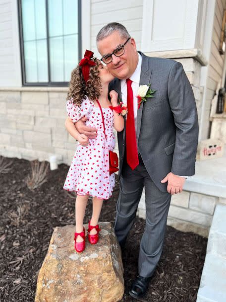 PHOTO: Austyn gives her grandfather, Steve Guenther, a kiss on the cheek. The 5-year-old and her grandpa attended a local Valentine's Day-themed daddy-daughter dance together last week. (Courtesy of Kelsey Woolverton)