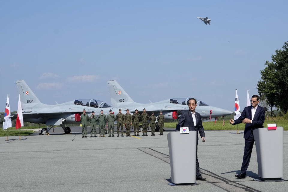 South Korean Prime Minister Han Duck-Soo, left, and his Polish host, Prime Minister Mateusz Morawiecki, right, attend a press conference following talks on regional security and the examination of the FA-50 fighter jets that Poland recently bought from South Korea, along with other military equipment, at an air base in Minsk Mazowiecki, eastern Poland, Wednesday, Sept. 13, 2023. Han was in Poland for talks on regional security amid war in neighboring Ukraine, and also to discuss military and nuclear energy cooperation. (AP Photo/Czarek Sokolowski)