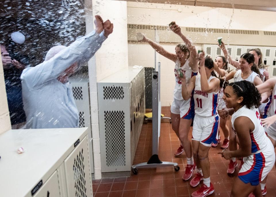 The Neshaminy girls basketball team celebrates in the locker room after clinching the division title with a win against Council Rock North, on Friday, February 2, 2024, at Neshaminy High School in Middletown.