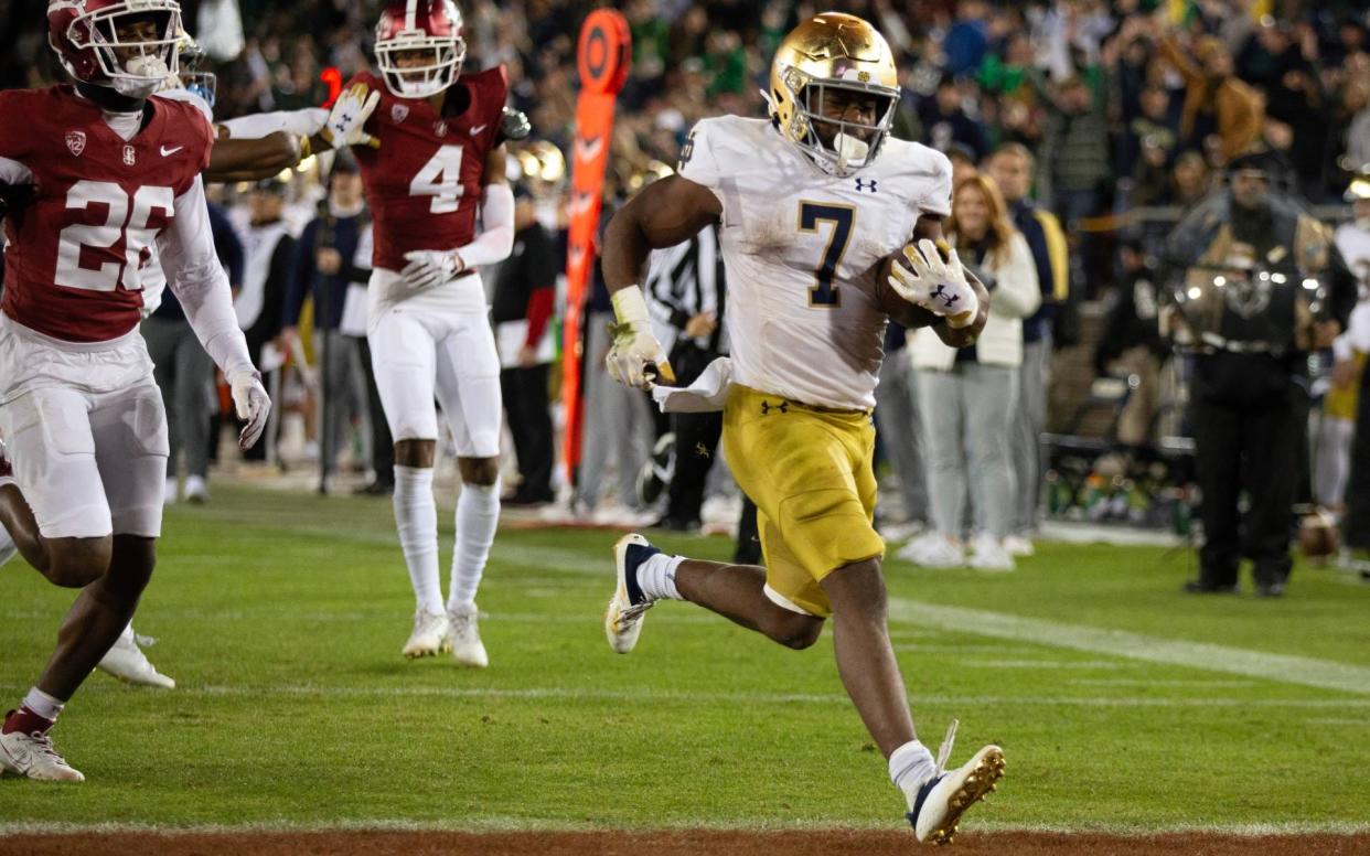 Nov 25, 2023; Stanford, California, USA; Notre Dame Fighting Irish running back Audric Estimé (7) breaks free for another touchdown run against the Stanford Cardinal during the third quarter at Stanford Stadium. Mandatory Credit: D. Ross Cameron-USA TODAY Sports