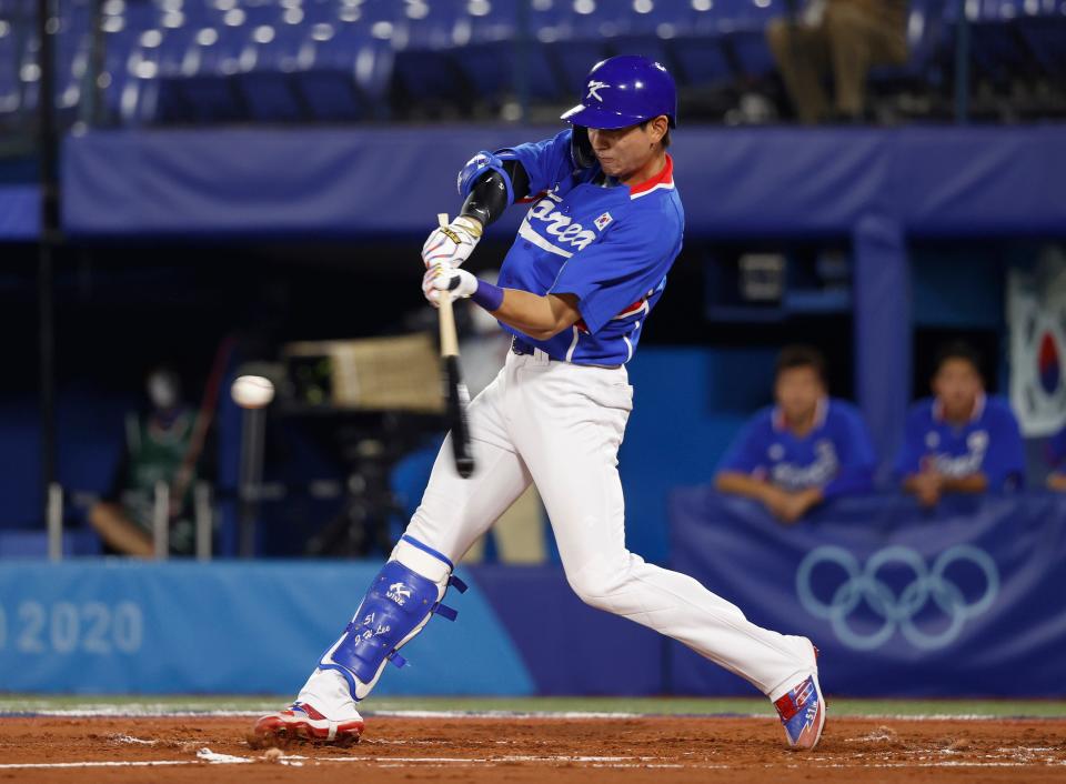 Team South Korea outfielder Jung Hoo Lee (51) hits a double against Japan in a baseball semifinal match during the Tokyo 2020 Olympic Summer Games at Yokohama Baseball Stadium.
