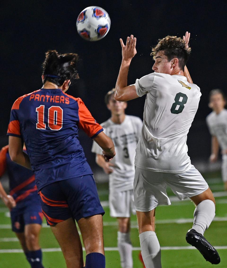 Bradenton Christian's Italo Zagaceta with a header against Saint Stephen's Alexander Slowik, on right, during Tuesday night's match at Dan van der Koy Field in Bradenton.