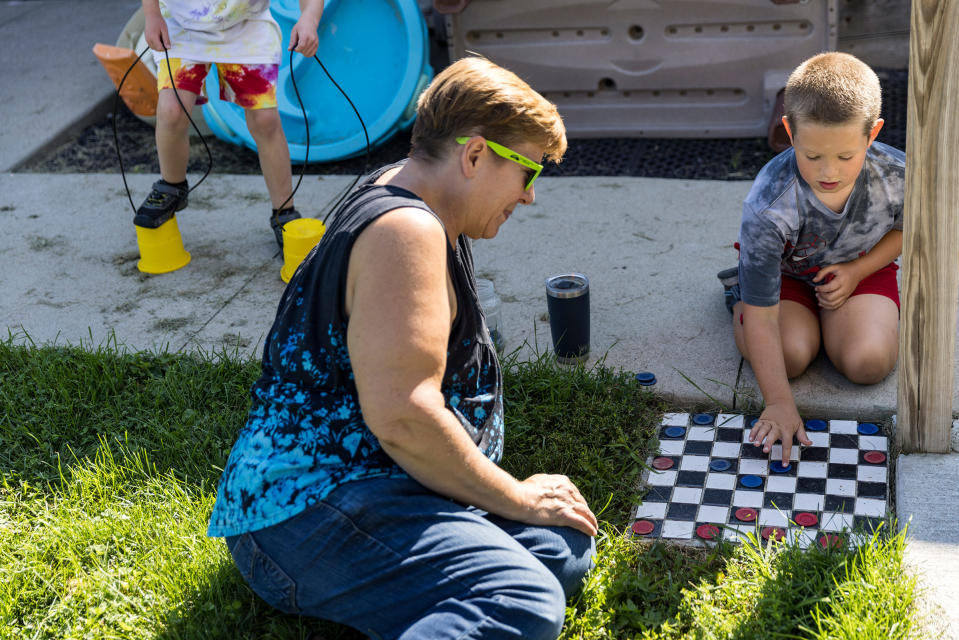 Deborah VanderGaast plays checkers with Brody Wendt, age 8.<span class="copyright">Kathryn Gamble for TIME</span>