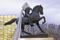 A tarp is stuck during the unveiling ceremony for a statue titled Rumor's of War by artist Kehinde Wiley at the Virginia Museum of Dine arts in Richmond, Va., Tuesday, Dec. 10, 2019. (AP Photo/Steve Helber)