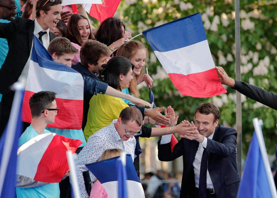<p>French independent centrist presidential candidate Emmanuel Macron, right, touches hands with supporters during a campaign rally in Albi, southern France, Thursday, May 4, 2017. The 39-year-old independent candidate faces far-right National Front leader Marine Le Pen in Sunday’s presidential runoff. (AP Photo/Christophe Ena) </p>