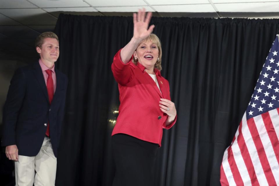 New Jersey Republican Lt. Gov. Kim Guadagno is followed by her son, Michael, as she takes the stage at her primary election night even, in Long Branch, N.J. (MEL EVANS / AP)