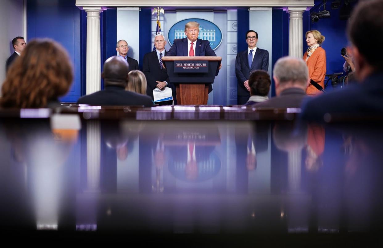 <span class="caption">President Donald Trump, flanked by administration and public health officials, during a briefing on the coronavirus on March 25.</span> <span class="attribution"><a class="link " href="https://www.gettyimages.com/detail/news-photo/president-donald-trump-flanked-by-response-coordinator-for-news-photo/1208243080?adppopup=true" rel="nofollow noopener" target="_blank" data-ylk="slk:Getty/Mandel Ngan / AFP;elm:context_link;itc:0;sec:content-canvas">Getty/Mandel Ngan / AFP</a></span>