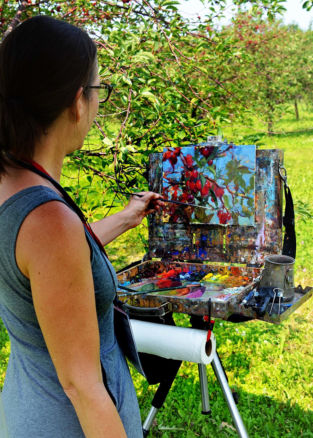 Suzie Baker of Texas visits a cherry orchard at Lautenbach's Orchard Country in Fish Creek to paint a scene during the 2021 Door County Plein Air Festival. Baker is one of 35 artists who will be in various locations around the Peninsula to paint what they see in front of them during the 2022 festival, which runs from July 24 to 30.