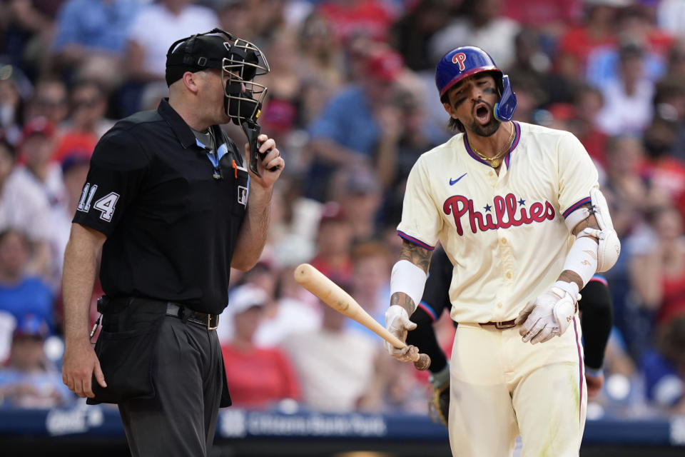 Philadelphia Phillies' Nick Castellanos, right, reacts to umpire Nate Tomlinson after striking out against Miami Marlins pitcher Calvin Faucher during the eighth inning of a baseball game, Saturday, June 29, 2024, in Philadelphia. (AP Photo/Matt Slocum)