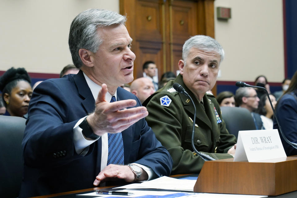 FBI Director Christopher Wray, left, testifies on Capitol Hill in Washington, Tuesday, March 8, 2022, during a House Permanent Select Committee on Intelligence hearing on worldwide threats. Seated next to Wray is National Security Agency Director Gen. Paul Nakasone, right. (AP Photo/Susan Walsh)