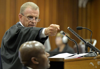 Gerrie Nel gestures as he demonstrates the firing of a gun during trial. (AP)