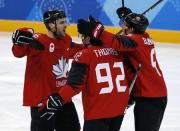 Ice Hockey - Pyeongchang 2018 Winter Olympics - Man’s Quarterfinal Match - Canada v Finland - Gangneung Hockey Centre, Gangneung, South Korea - February 21, 2018 - Maxim Noreau of Canada celebrates his goal with Christian Thomas and Chay Genoway. REUTERS/Brian Snyder