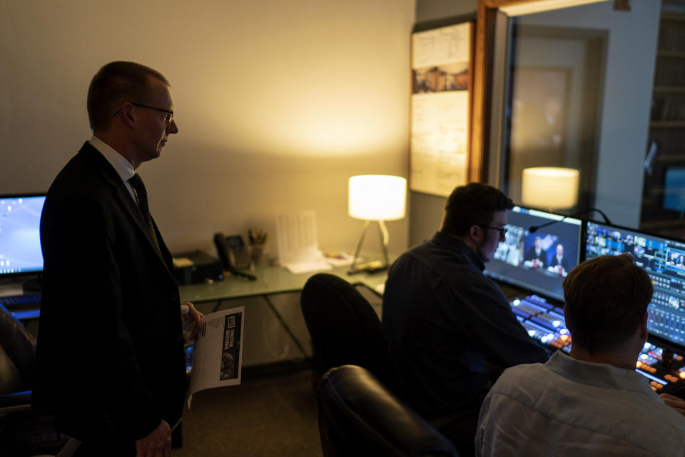 CEO Bill Hahn watches a live broadcast from a production booth at the headquarters of the John Birch Society in Appleton, Wis., Thursday, Nov. 17, 2022. (AP Photo/David Goldman)