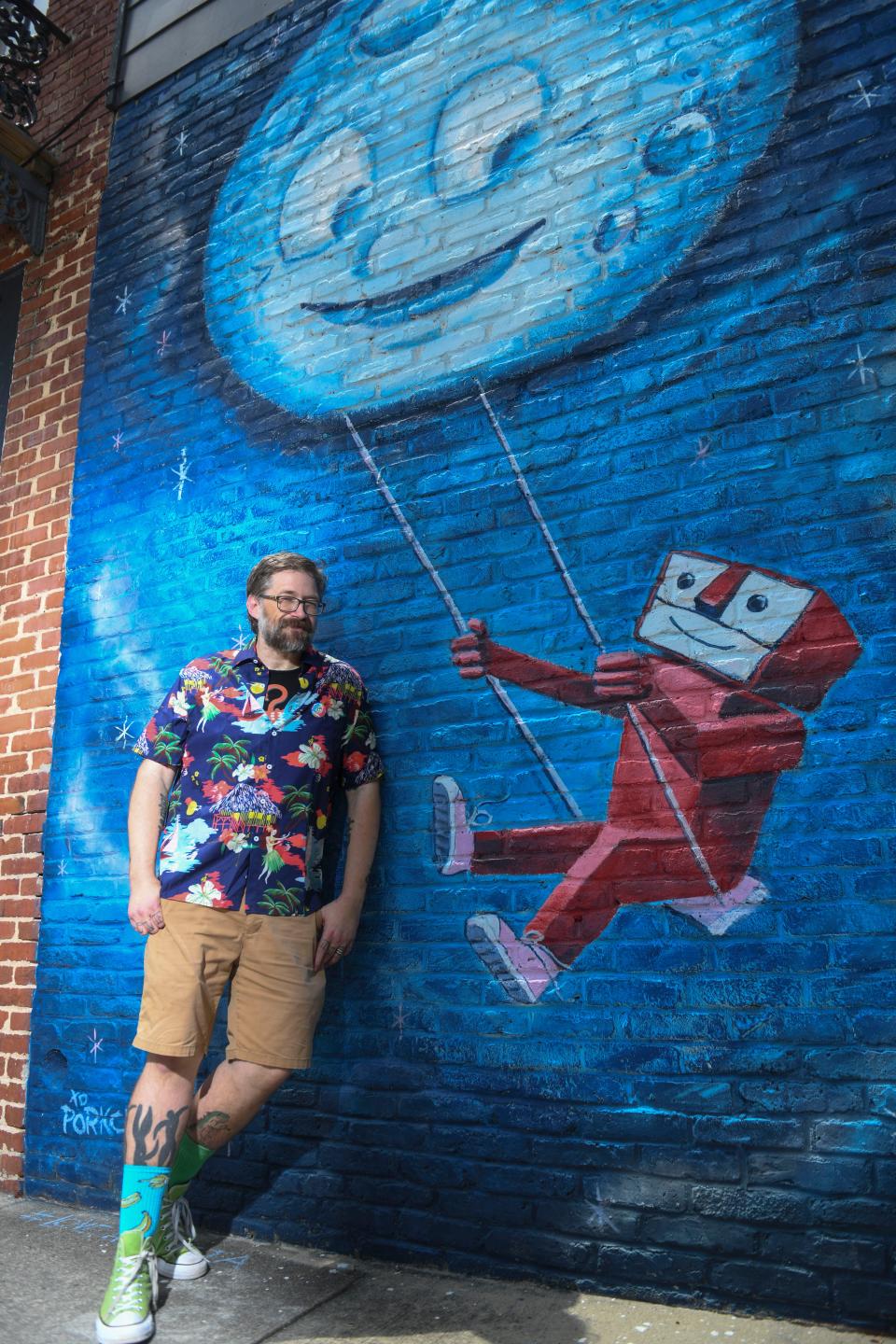 Leonard “Porkchop” Zimmerman poses for a portrait in front of his mural “Robot and the Moon” in downtown Augusta on Monday, Aug. 14, 2023.