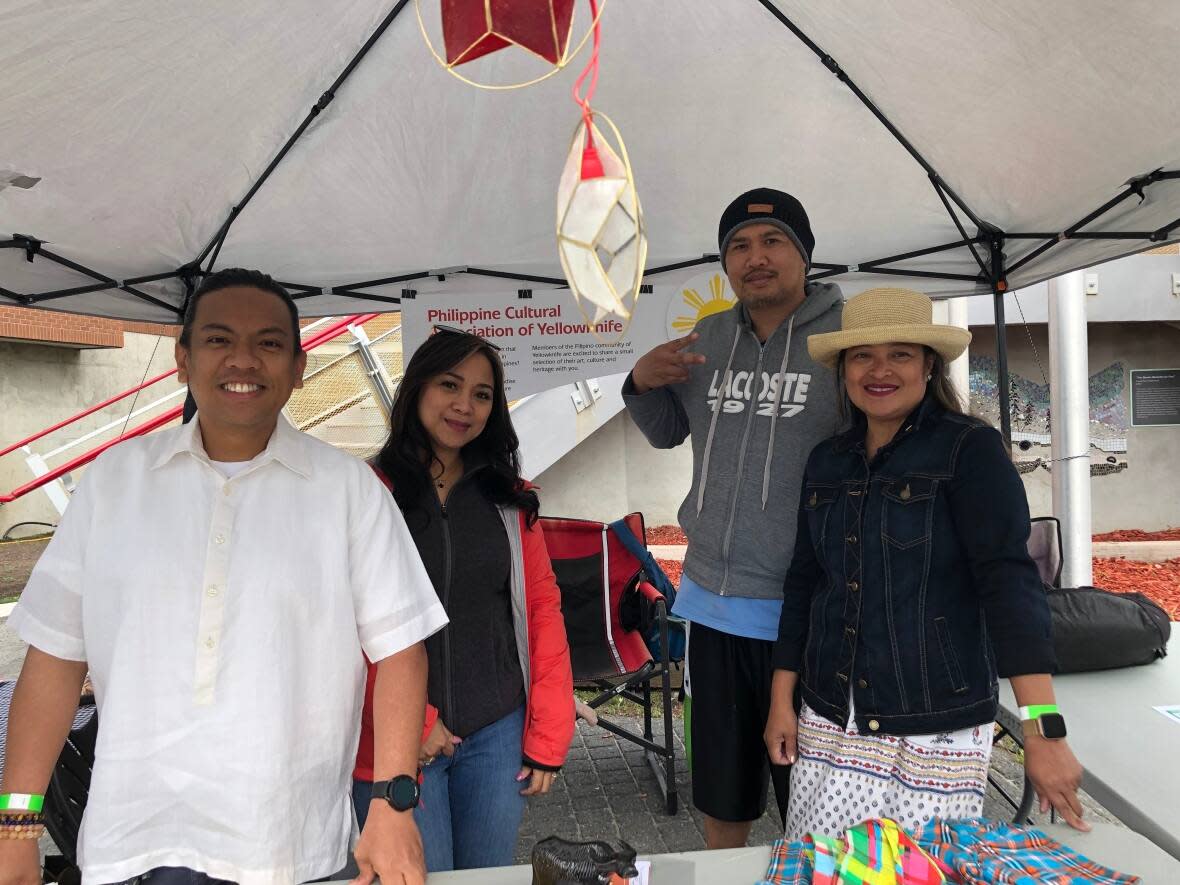 Lea Barbosa-Leclerc, left, is president of the Philippine Cultural Association of Yellowknife. She and several other members ran a booth at the Sǫǫ̀mba K’è Multicultural Festival on Sunday.  (Luke Carroll/ CBC - image credit)