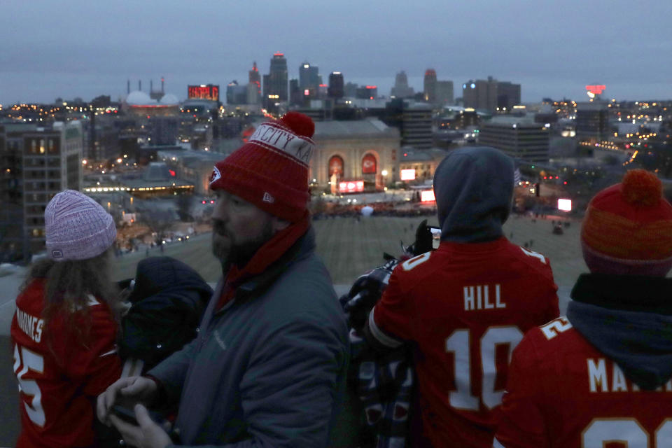 People gather at the Liberty Memorial as they wait for a parade through downtown Kansas City, Mo. to celebrate the Kansas City Chiefs victory in NFL's Super Bowl 54 Wednesday, Feb. 5, 2020. (AP Photo/Charlie Riedel)