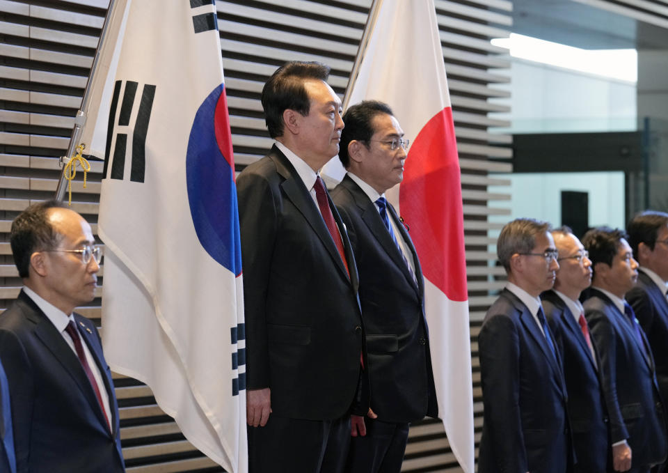South Korean President Yoon Suk Yeol, center left, and Japanese Prime Minister Fumio Kishida, center right, attend an honor guard ceremony, ahead of their bilateral meeting at the Prime Minister's Office, in Tokyo, Japan, Thursday, March 16, 2023. (Franck Robichon/Pool Photo via AP)