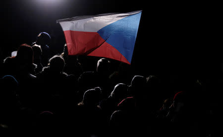 Demonstrators hold a national flag as they march during a protest rally demanding resignation of Czech Prime Minister Andrej Babis in Prague, Czech Republic, November 23, 2018. REUTERS/David W Cerny