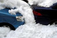 Snow covers cars on the street in Madrid