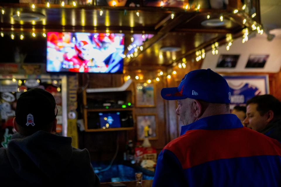 Eugene "Mel" Smaszcz, manager of the Big Tree Inn, just down Abbott Road from the Buffalo Bills' Highmark Stadium in Orchard Park, New York, watches the Kansas City Chiefs and the Cincinnati Bengals play in the AFC Championship on Jan. 30, 2022.  Smaszcz said the end of the Bills season will cost him roughly $80,000 per Sunday, as Bills fans won't pack his place as they typically do on game days.