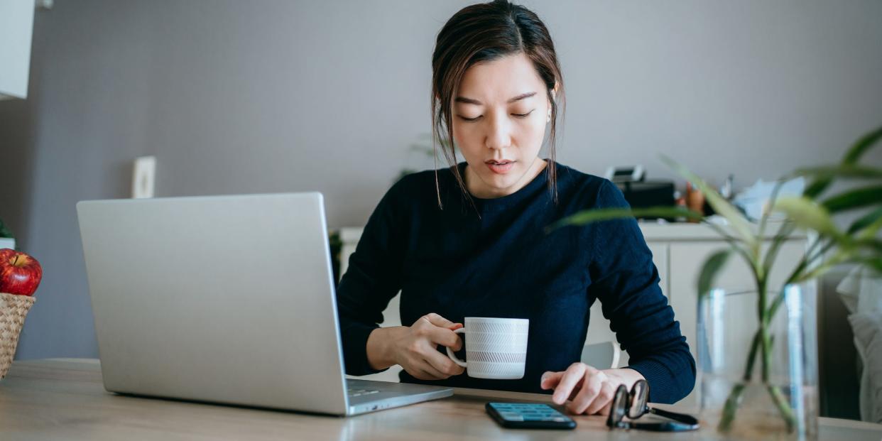 professional using laptop and smartphone at home