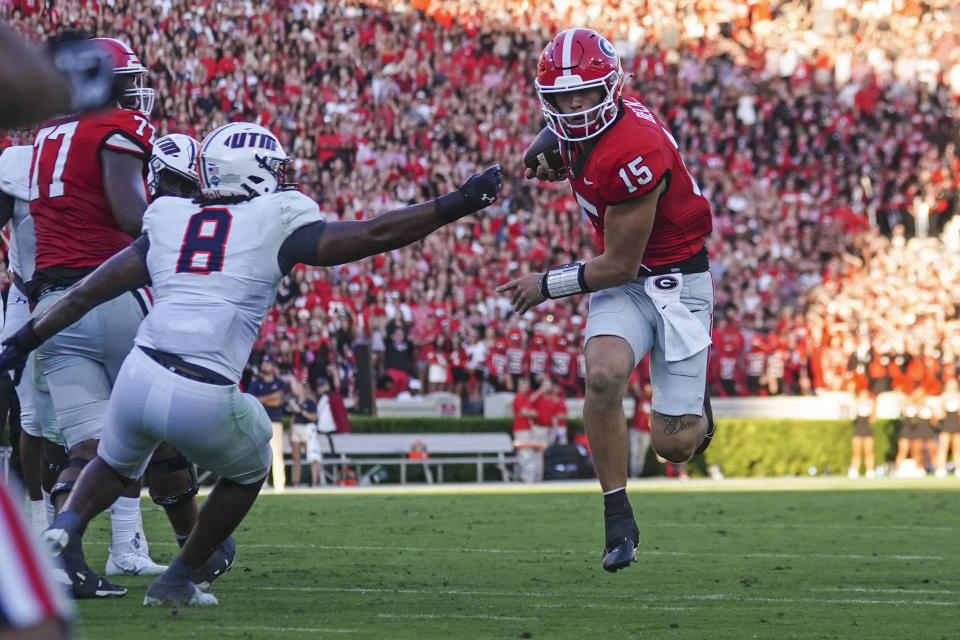 Georgia quarterback Carson Beck (15) runs past Tennessee-Martin linebacker Giovanni Davis (8) to score a touchdown during the first half of an NCAA college football game Saturday, Sept. 2, 2023, in Athens, Ga. (AP Photo/John Bazemore)