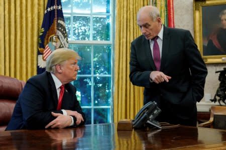 FILE PHOTO: U.S. President Donald Trump speaks to White House Chief of Staff John Kelly after an event with reporters in the Oval Office at the White House in Washington, U.S. October 10, 2018.  REUTERS/Jonathan Ernst/File Photo