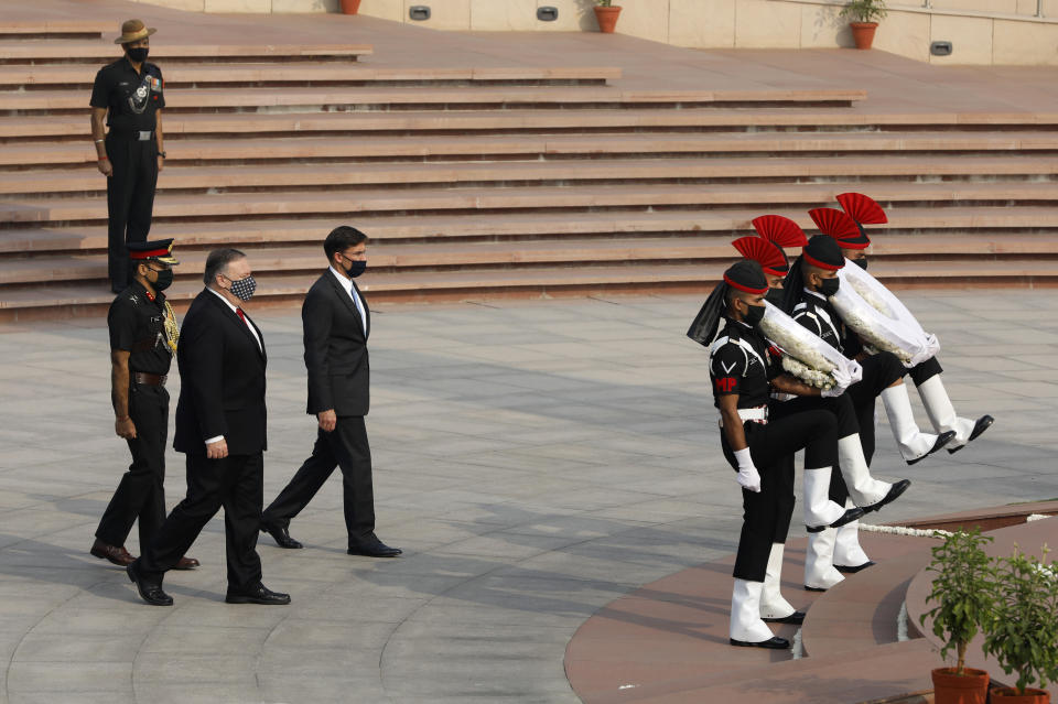 U.S. Secretary of State Mike Pompeo and Secretary of Defence Mark Esper arrive to pay their tributes at the National War Memorial in New Delhi, India, Tuesday, Oct. 27, 2020. In talks on Tuesday with their Indian counterparts, Pompeo and Esper are to sign an agreement expanding military satellite information sharing and highlight strategic cooperation between Washington and New Delhi with an eye toward countering China. (Adnan Abidi/Pool via AP)