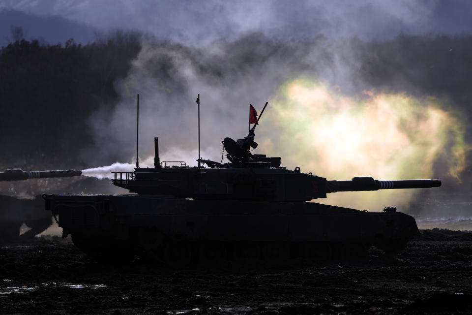 Japanese Ground-Self Defense Force (JGDDF) Type 90 tanks fire their guns at a target during the annual drill with live ammunitions exercise at Minami Eniwa Camp in Eniwa, northern Japan island of Hokkaido on Dec. 6, 2021. Japan has been building up its defenses to counter strategic threats, but its arms industry is struggling both on the home front and overseas. (AP Photo/Eugene Hoshiko)