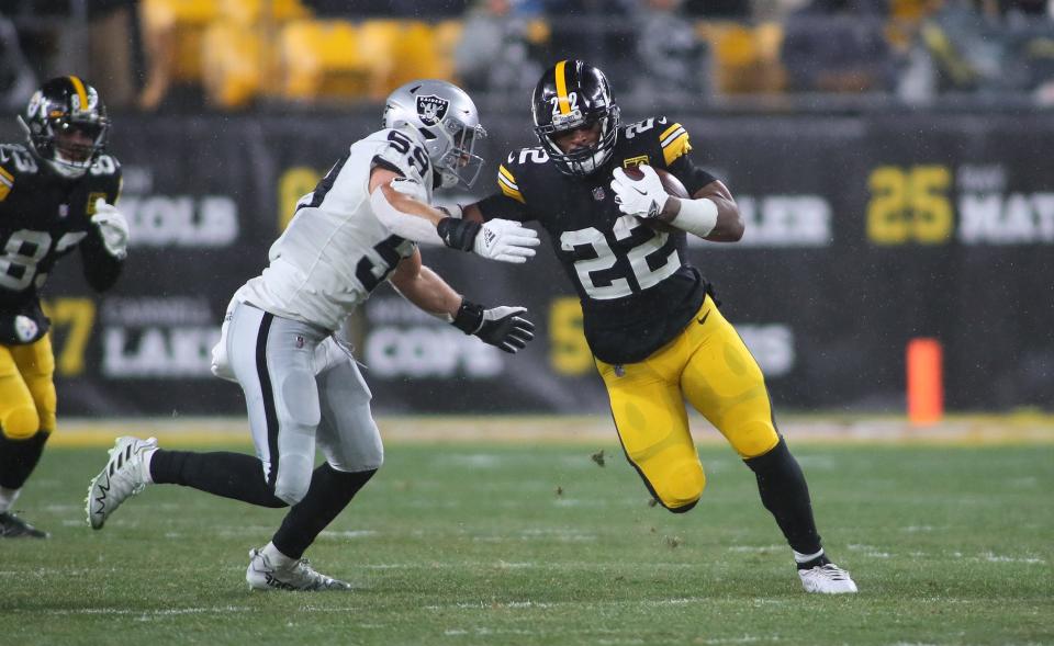 Pittsburgh Steelers Najee Harris (22) stiff arms Las Vegas Raiders Luke Masterson (59) during the first half at Acrisure Stadium in Pittsburgh, PA on December 24, 2022.