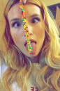 The actress hit up Dave & Busters, getting silly with a rope of Nerds candy.