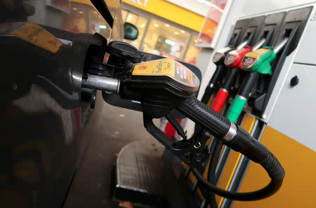 FILE PHOTO: A diesel fuel nozzle is seen attached to a car at a Shell petrol station in Berlin, Germany October 22, 2018. REUTERS/Fabrizio Bensch/File Photo