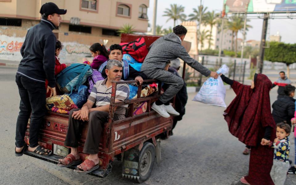 Palestinians riding on an auto rickshaw flee during Israeli air and artillery strikes as cross-border violence between the Israeli military and Palestinian militants continues, in the northern Gaza Strip - Mohammed Salem/REUTERS