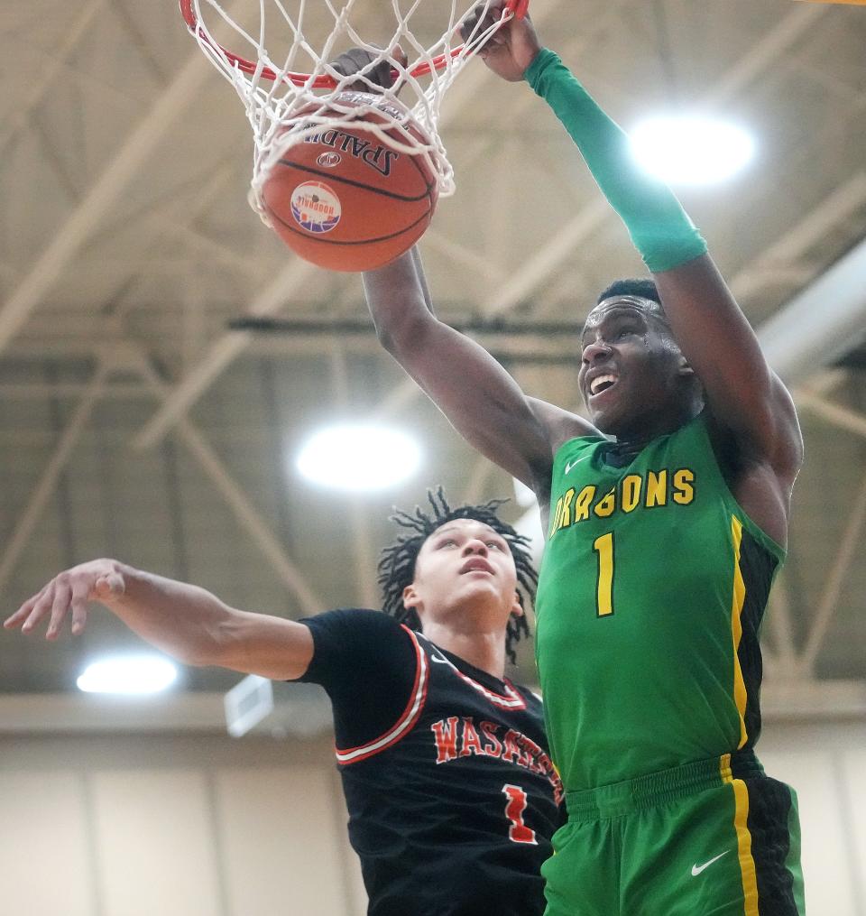 AZ Compass Prep Dragons’ Mookie Cook (1) dunks the ball over Wasatch Academy Tigers' Isiah Harwell (1) at Chaparral High School in Scottsdale on Dec. 9, 2022.