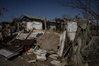 A youth plays amid the remains of a home destroyed by Hurricane Ian in La Coloma, in the province of Pinar del Rio, Cuba, Wednesday, Oct. 5, 2022. (AP Photo/Ramon Espinosa)