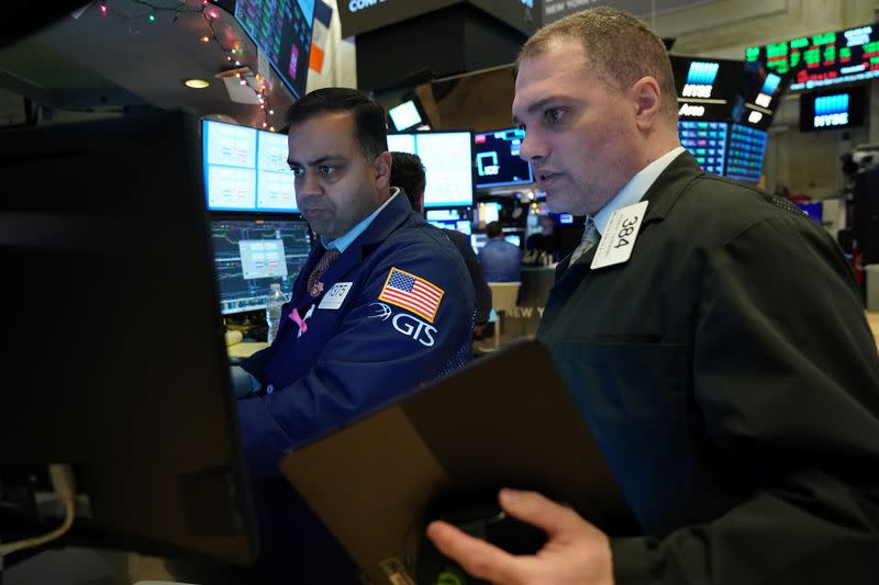 Traders work at the New York Stock Exchange