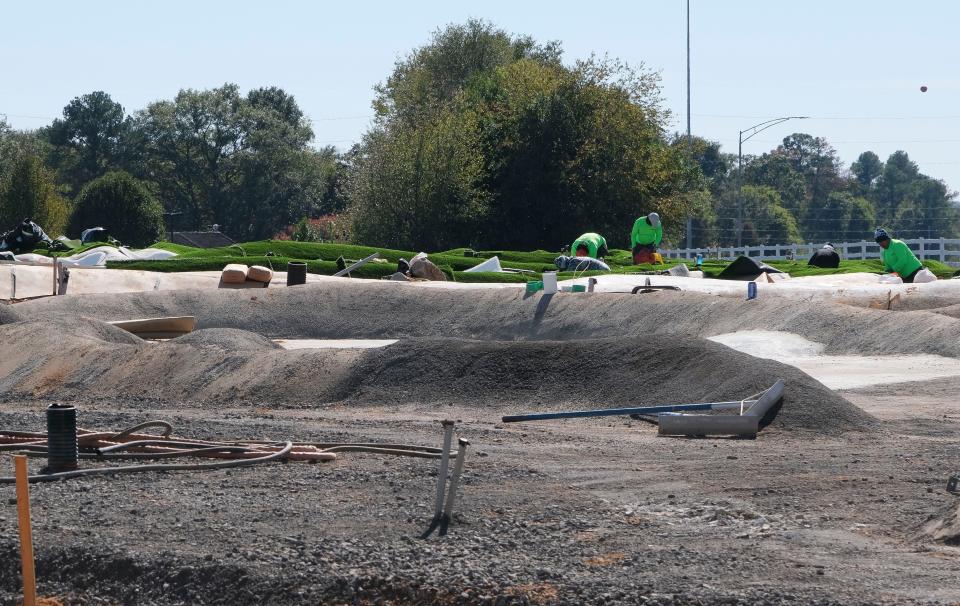 Workers build the PopStroke mini-golf facility in Tuscaloosa on Nov. 2, 2023.