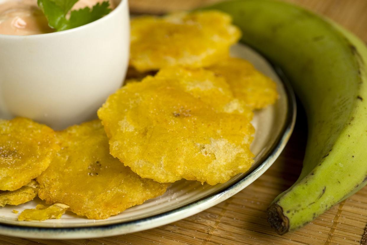 tostones and plantain with sauce in small bowl on the side